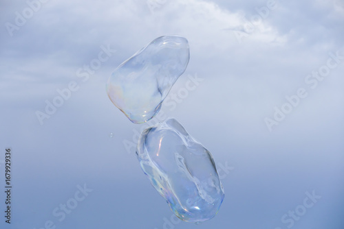 Huge bubble with blue sky and white cloud background