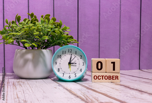 October 1st. Image of october 1 wooden color calendar on blue background.