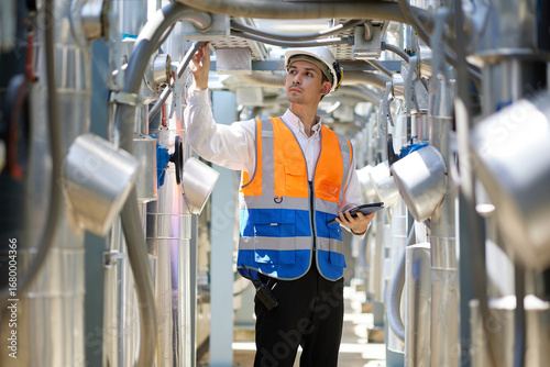 Engineer or technician looking above and checking air conditioner control valve at plumbing systems