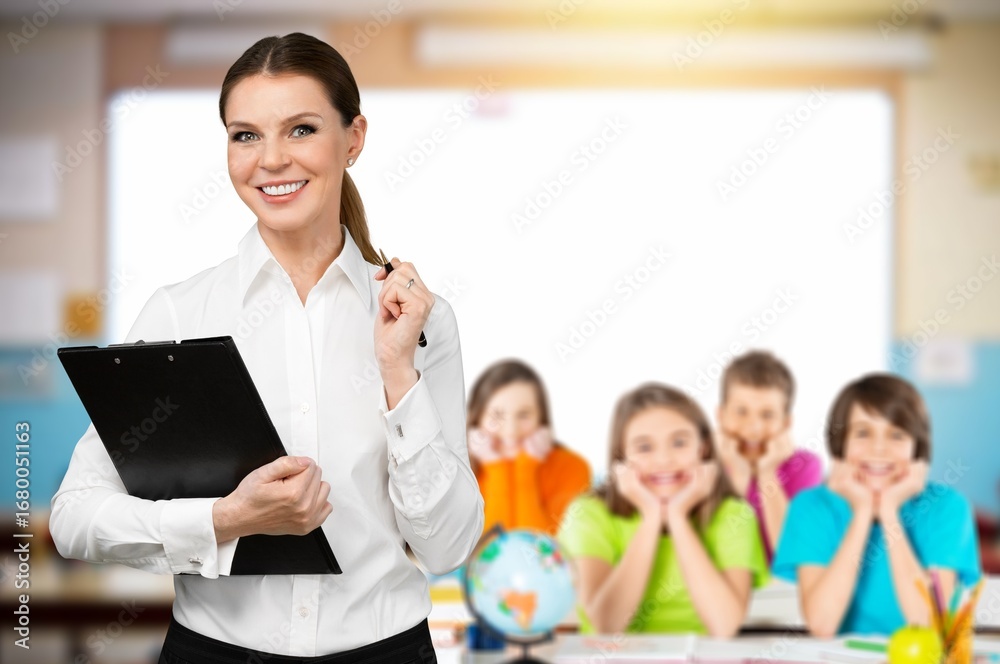 Fototapeta premium Portrait of cheerful female teacher in classroom