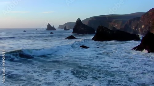 Dramatic Coastline With Sea Stacks And Crashing Waves At Sunset