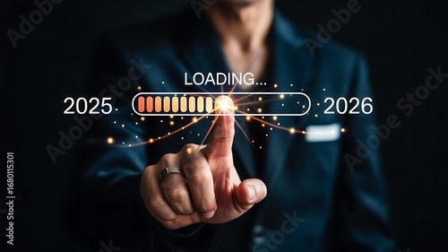 Person s finger touching a loading bar indicating progress from year 2025 to 2026 with digital futuristic elements