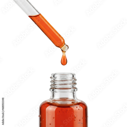 Precise drop of amber serum falling from pipette into clear glass bottle for skincare