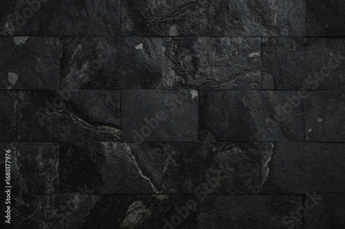 Dark gray stone wall, rectangular tiles