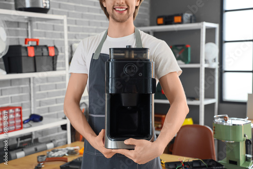 Male repairman with coffee ...