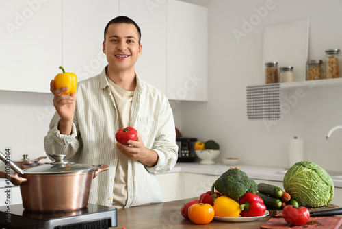 Young man with bell peppers...