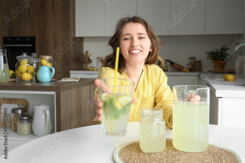 Young woman with tasty lemo...