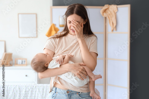 Stressed young mother suffe...