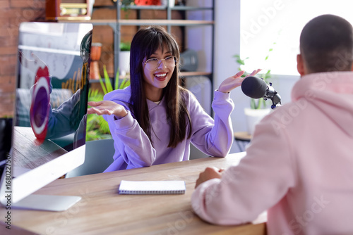 Young woman talking to podc...
