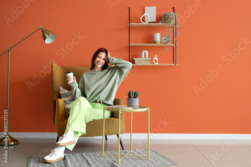 Young woman with coffee cup...