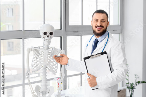 Male doctor with clipboard ...