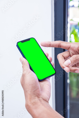 Holding mobile phone showing screen for mockup, mobile app using. 