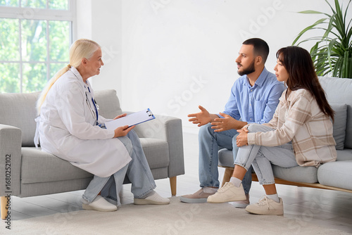 Young couple talking to fer...
