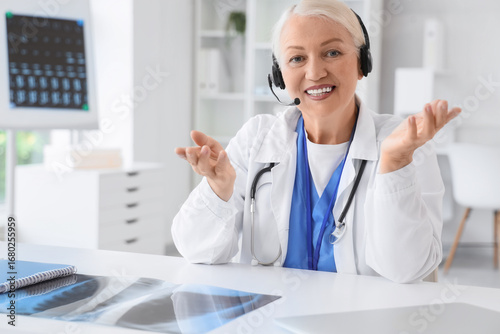 Female doctor in headset gi...