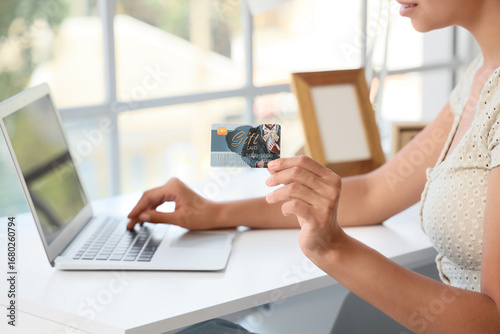 Young woman with gift card ...