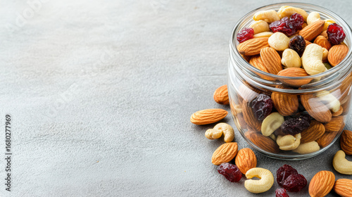 Fototapeta Naklejka Na Ścianę i Meble -  Mixed nuts and dried fruits in glass jar create healthy snack option