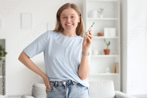Young woman with syringe of...