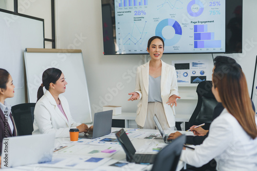 Obraz na plátně Businesswoman presenting company performance data to colleagues during a meeting