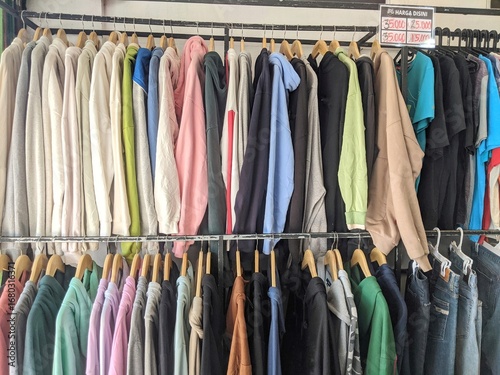 Wallpaper Mural Used or auctioned clothes that are hung and sold at the market Torontodigital.ca