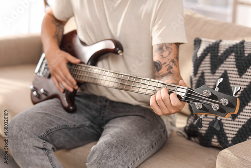 Young man playing electric ...