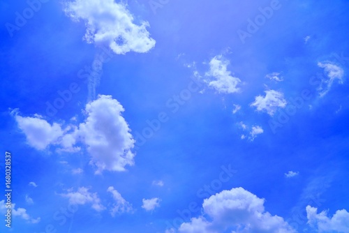 Фотография Whimsical little clouds floating playfully across the sky, shaped like butterfli