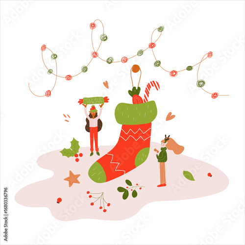 Two miniature elves put candy in a Christmas sock. Winter. New Year. Christmas. 