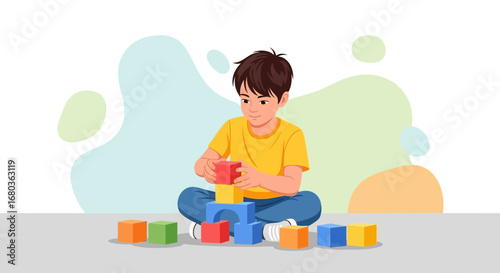 A young boy playing with blocks to build something in a creative way concept