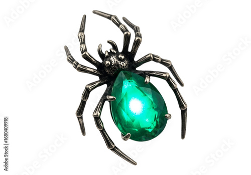 Striking spider brooch features a luminous emerald-green gemstone, showcasing intricate metallic detailing against a stark black background.