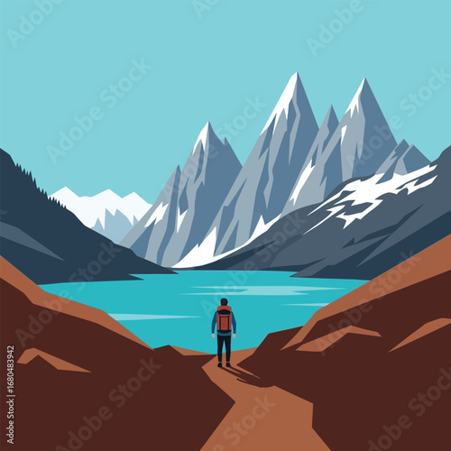 A lone hiker stands on a path overlooking a turquoise lake and snow-capped mountains under a clear blue sky.