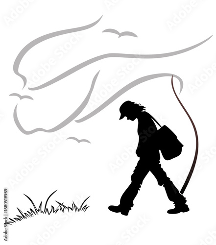 Silhouette of a person walking with a backpack in a breezy landscape  
