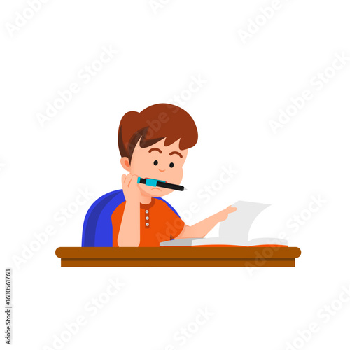 A boy reads a book at a desk while biting a pen, deep in thought