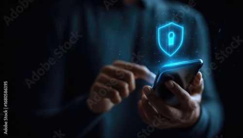 Close-up of hands holding a phone with a glowing shield and lock graphic overlay