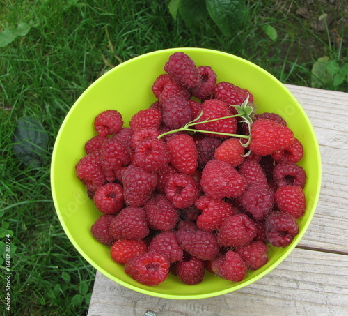 raspberries in a bowl on a wooden table