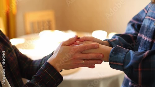 Experience the intimacy of a young couple as they gently caress each others hands in a close up view