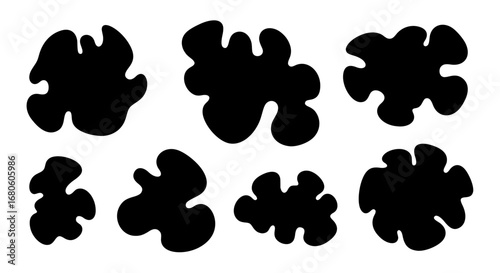A set of isolated black amorphous liquid shapes. Simple vector illustration of organic blobs or inkblots, perfect for creating patterns like cow print.