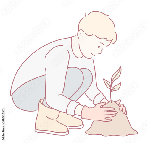 A boy is planting a tree seedling in rich soil, promoting environmental awareness and responsibility