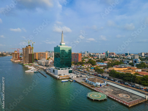 Aerial view of the iconic green and silver Civic Towers reflecting the sky, contrasting with the dark waters of the lagoon, Ozumba Mbadiwe Avenue, Lagos, Lagos, Nigeria.