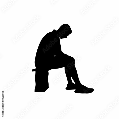 Silhouette of a young man sitting alone on a bench reflecting on his mistakes