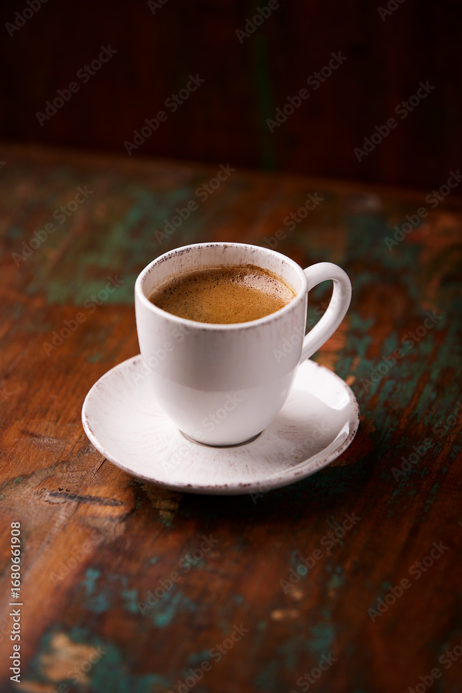 Fototapeta premium Cup of coffee on rustic wooden background. Soft focus. Copy space 