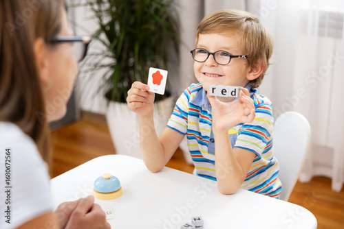 Child Learning Colors with Flashcards in Educational Setting