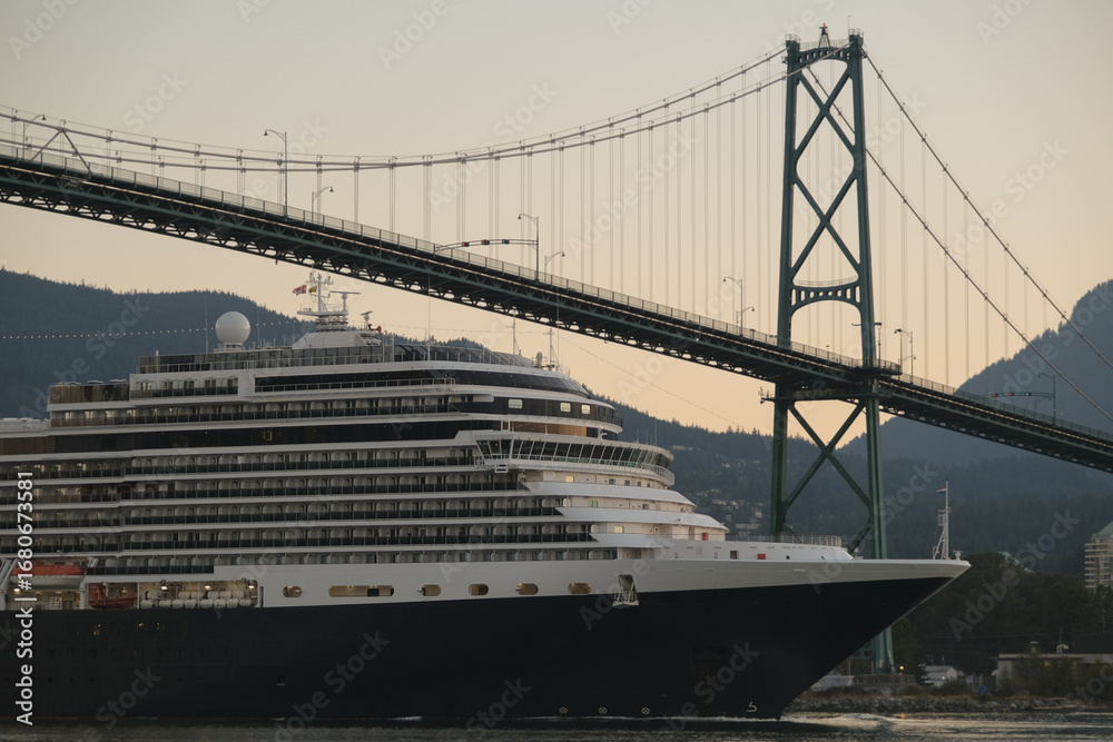 Obraz premium Modern classic cruiseship or cruise ship liner Nieuw Amsterdam arrival into Vancouver port, Canada during sunrise after cruise to Alaska with Stanley Park landscape