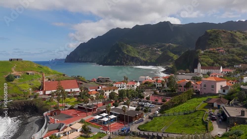 Aerial Drone Shot Flying Low Over White Washed Rooftops Towards The Atlantic Ocean In Porto Da Cruz, Madeira, Portugal.