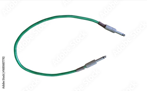 Green audio jack cable with metal connectors for musical instruments and sound equipment isolated on white background