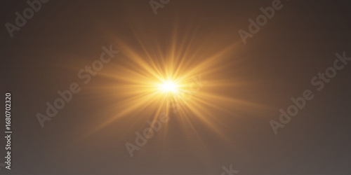 Bright golden lens flare with luminous rays and optical flares.