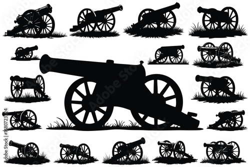 Collection of vintage cannons in silhouette on grass