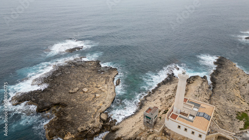 Rocky coastal cliff with natural arch in Faro, Algarve, Portugal