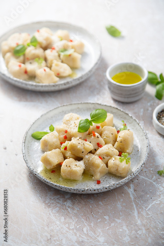 Homemade potato gnocchi with basil and chilli