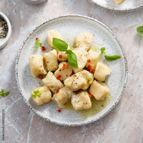 Homemade potato gnocchi with basil and chilli