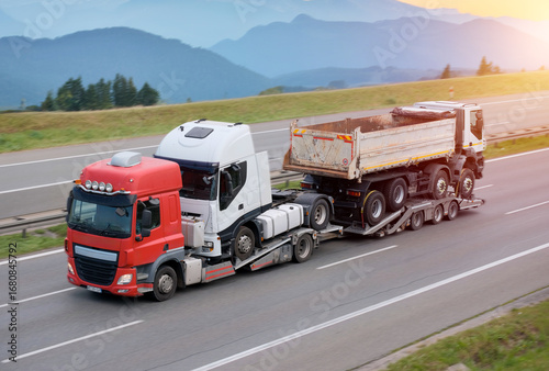 Bild auf Leinwand Heavy-Duty Vehicle Transporting Two Semi-Trailer Trucks