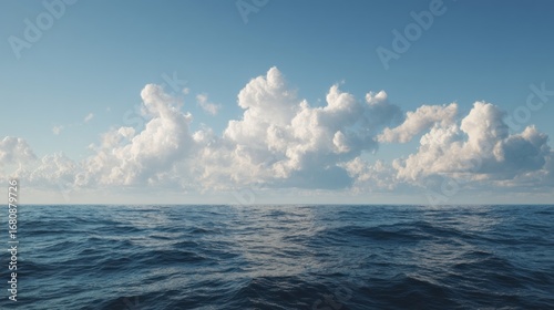 Vast ocean expanse meeting a soft cloudy sky on a bright sunny day